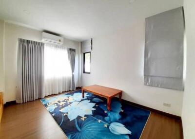 Spacious living room with a wooden table and large window