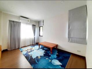 Spacious living room with a wooden table and large window