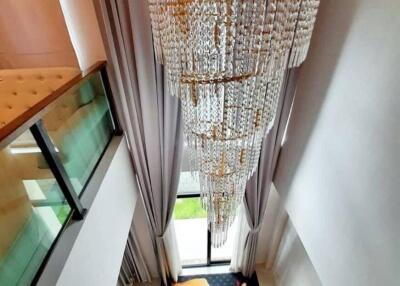 Elegant dining room with grand chandelier and tall curtains