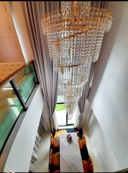 Elegant dining room with grand chandelier and tall curtains