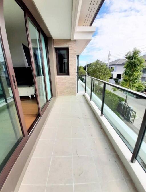 Balcony with glass railing and a view of the neighborhood