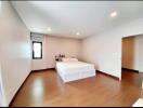 Spacious bedroom with double bed and wooden flooring