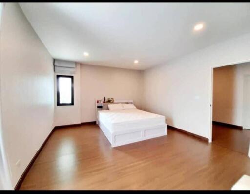 Spacious bedroom with double bed and wooden flooring