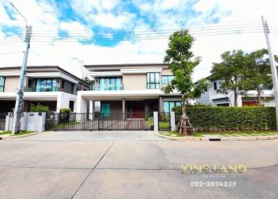 Front view of a modern two-story house with a gated entrance