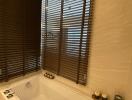 Bathroom with bathtub and blinds