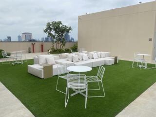 Rooftop patio with seating area and tables