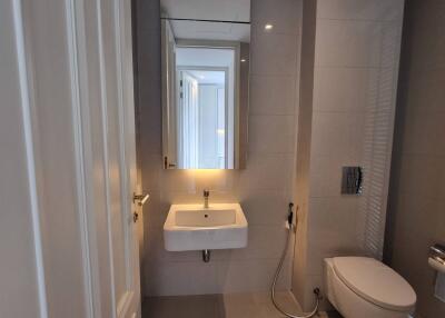 Modern bathroom with sink, mirror, and toilet