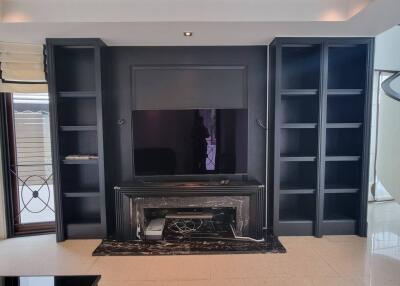 Modern living room with built-in shelving and a fireplace