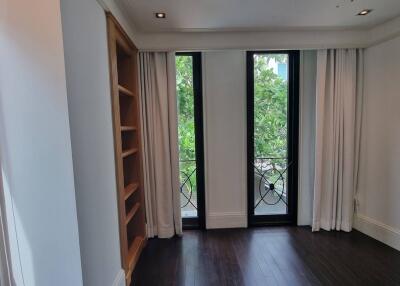 Bright living room with large windows and built-in shelves