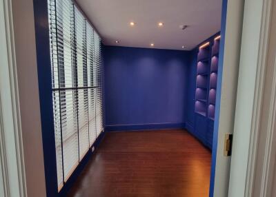 Empty room with blue walls and wooden floor