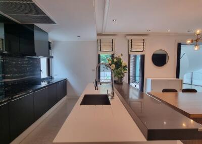 Modern kitchen with marble backsplash and dining area