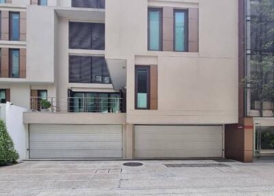 Modern residential building exterior with multiple garage doors