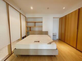 Spacious bedroom with large wardrobe and shelves