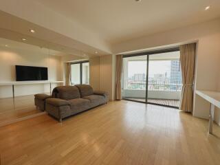 Spacious living room with a large window and a couch