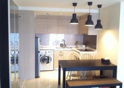 Modern kitchen and dining area with pendant lights