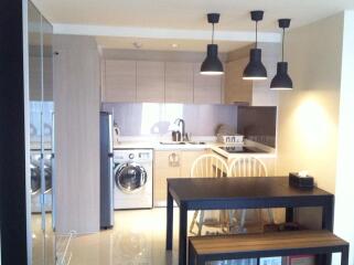 Modern kitchen and dining area with pendant lights