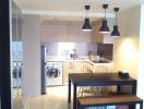 Modern kitchen and dining area with pendant lights