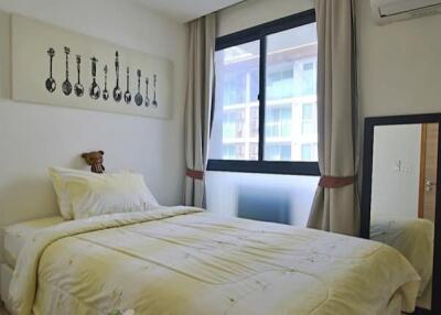 Bedroom with bed, window, and wall art