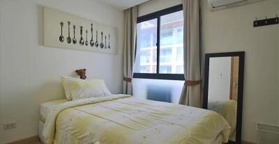 Bedroom with bed, window, and wall art