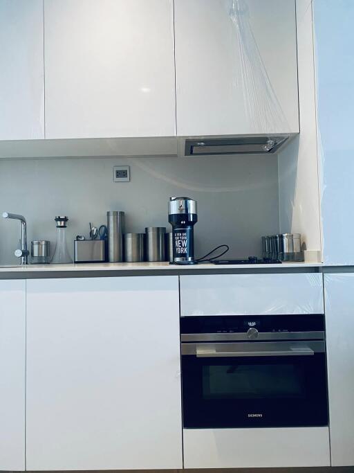 Modern kitchen with white cabinets and stainless steel appliances