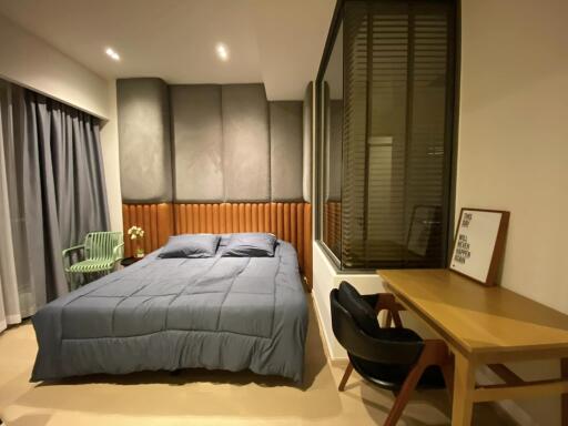 Modern bedroom with bed, curtains, and desk