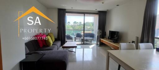 Modern living room with large windows and balcony