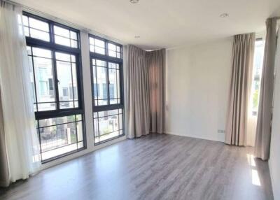 Bright living room with large windows and hardwood floors