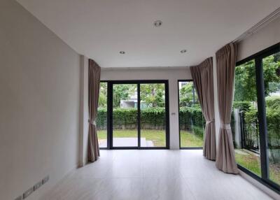 Spacious living room with large windows and garden view