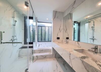 Modern marble bathroom with glass shower and bathtub