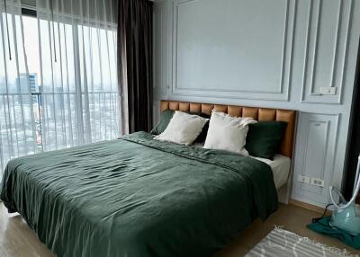 Master bedroom with large bed and floor-to-ceiling windows