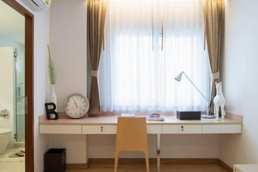 Bright bedroom with a study desk by the window