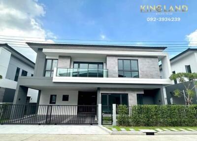 Modern two-story house with a front garden and garage