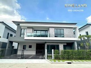 Modern two-story house with a front garden and garage