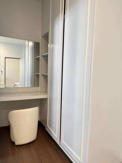 Bedroom with vanity desk and sliding door closet