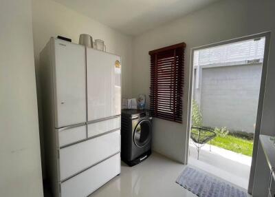 Laundry room with refrigerator and washing machine