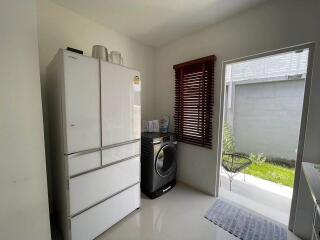 Laundry room with refrigerator and washing machine