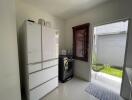 Laundry room with refrigerator and washing machine