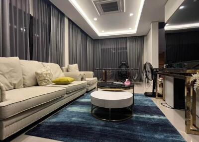 Modern living room with large sofa and decorative lighting