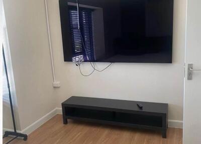 Bedroom with TV on wall