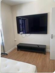 Bedroom with TV on wall