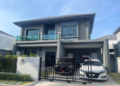 Two-story modern house with garage and cars