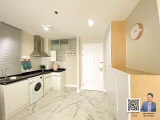 Modern kitchen with white cabinets and marble flooring