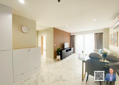 Modern living room with marble flooring and natural light