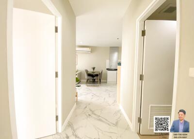 Well-lit hallway leading to open living area