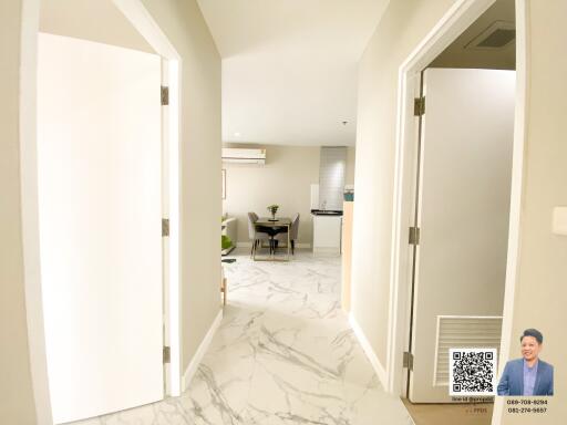 Well-lit hallway leading to open living area