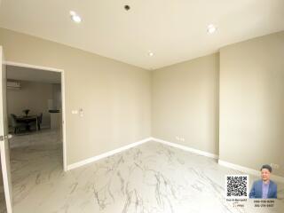 Bright living space with marble flooring and recessed lighting