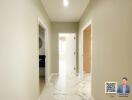 Bright hallway with marble flooring leading to different rooms