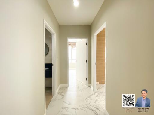 Bright hallway with marble flooring leading to different rooms