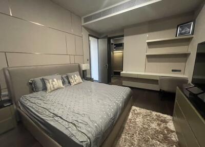 Modern bedroom with bed, desk, and open closet