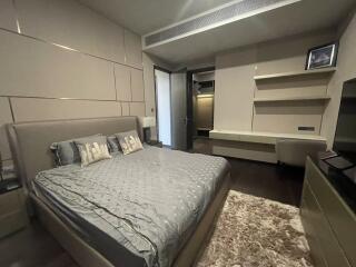 Modern bedroom with bed, desk, and open closet